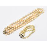 A double strand simulated pearl bracelet with silver clasp, stamped 925, with a double row