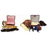 Two suitcases containing fur shawls.