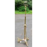 An early 20th century Arts and Crafts brass plated and copper rise and fall standard lamp, converted