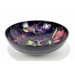 MOORCROFT; an 'Anemone' pattern bowl, impressed marks and painted initials, diameter 26cm.