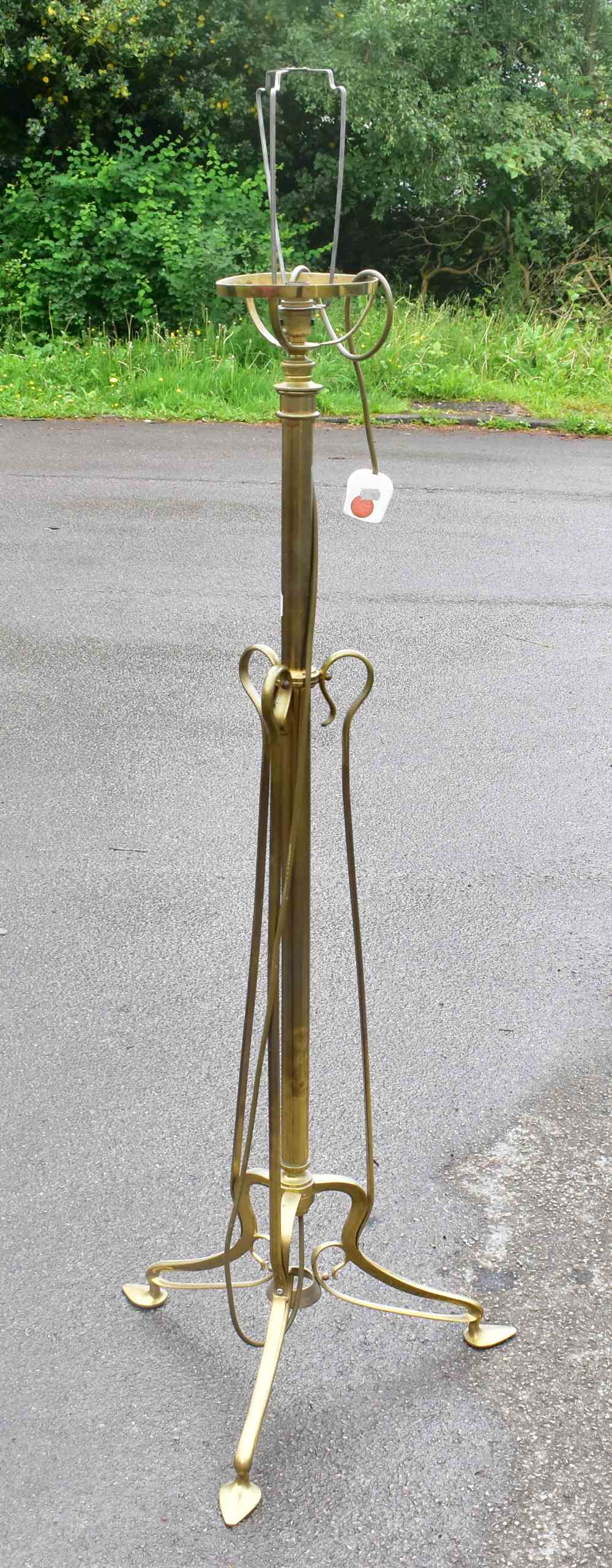 An early 20th century brass rise and fall standard lamp converted to electricity, height 132cm.