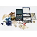 A collection of costume jewellery necklaces, with a pair of cufflinks and cased plated flatware.
