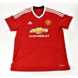 ERIC CANTONA; a Manchester United 2015 home shirt, signed to the reverse, size large.Additional