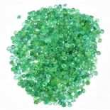 EMERALDS; a group of round facet cut stones weighing 30ct, each 2mm.