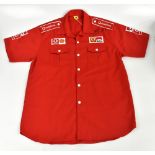 MICHAEL SCHUMACHER; a Ferrari racing shirt, signed to the front, size XXL.Additional