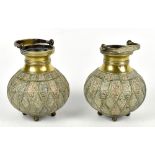 A pair of good 19th century Eastern baluster shaped vases with swing handles, on four ball feet,