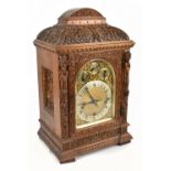 WINTERHALDER & HOFMEIER; a 19th century oak quarter repeating mantel clock, the brass dial with a
