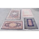 Four decorative Eastern rugs including an example with stylised floral decoration on a blue and