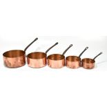 A graduated set of five French copper saucepans with wrought iron handles, the largest 33cm