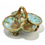 GEORGE JONES; a Victorian majolica basket with four wells with leaf and flower decoration and raised