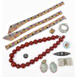 A small collection of costume jewellery to include bakelite beads, an enamel brooch decorated with