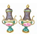 MINTONS; a pair of late 19th century green ground gilt heightened reticulated vases and covers,