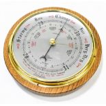 SHORTLAND SMITHS; a modern oak cased aneroid barometer with silvered dial, diameter 20cm.