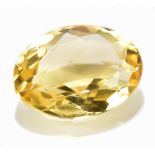 CITRINE; an oval facet cut stone weighing 27.29ct, measuring 23mm x 17.5mm.