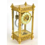 A late 19th century French gilt brass four glass mantel clock, with Roman numeral chapter ring and