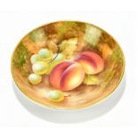 HOLLAND FOR ROYAL WORCESTER; a hand painted circular pin dish decorated with fruit, black painted