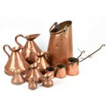 A graduated set of seven 19th century copper haystack jugs, together with three copper measures