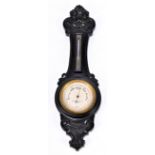 REYNOLD & BRANSON LTD OF LEEDS; a miniature aneroid barometer in ebony case in the form of a wheel