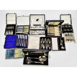 A collection of assorted silver plated flatware and serving sets.