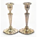 HAMPTON UTILITIES; a pair of Elizabeth II hallmarked silver candlesticks of oval form Birmingham