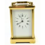 ANGELUS; a modern gilt brass carriage clock with swing brass handle above the enamel dial set with