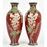 A pair of Japanese cloisonné vases, decorated with wisteria against a white ground, height 21cm.