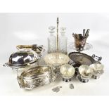 A collection of silver plated items including decanters with stand, pierced dishes, ice bucket, etc.