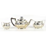 MARK WILLIS; a late Victorian hallmarked silver three piece tea service with gadrooned lower