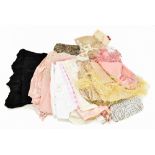 Nine items of early 20th century undergarments, including a white cotton and lace square neck top, a