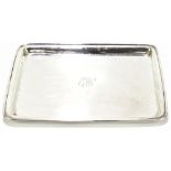 A George V hallmarked silver dressing table tray of rectangular form with engraved initials 'EJW' to