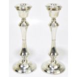 W.I BROADWAY & CO; a pair of Elizabeth II hallmarked silver candlesticks, with detachable sconces,