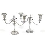 ELLIS & CO; a pair of Edward VII hallmarked silver three branch candelabra, on fluted stems with