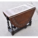 An 18th century and later carved oak gateleg table with turned and block legs, height 65cm, width