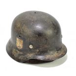 A German military helmet with traces of decal.