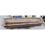 A large cast iron garden trough, length 189cm, width 40cm, height 25cm.