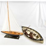 A scratch built single mast yacht with sails and miniaturised detail, body painted in green on