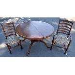 A reproduction oak circular topped extending dining table with one additional leaf, raised on four