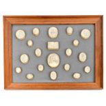 A collection of twenty early 19th century grand tour plaster gems, on later backing and frame, the