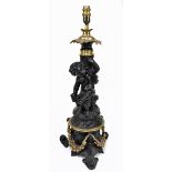 A spelter and brass cherubic figural table lamp on scrolling tripartite base, height including