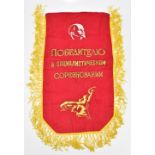 A Russian red and gold thread pennant inscribed in Cyrillic 'To The Winner in Socialist