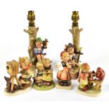 HUMMEL; a pair of figural lamps and four small figures (6).