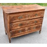 An 18th century French carved oak chest, with three long drawers decorated with floral detail on