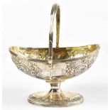 JOHN EMES; a George III hallmarked silver gilt oval basket with swing handle and floral