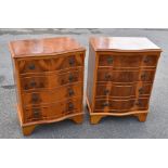 A pair of reproduction yew wood veneered serpentine fronted chest of four drawers, on bracket