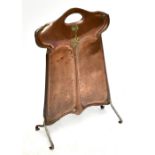 An Art Nouveau copper fire screen of shaped rectangular form, with planished decoration and