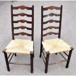 A set of four oak rush seated ladder back dining chairs. (4)