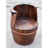 A copper bound oak barrel chair, height 70cm.