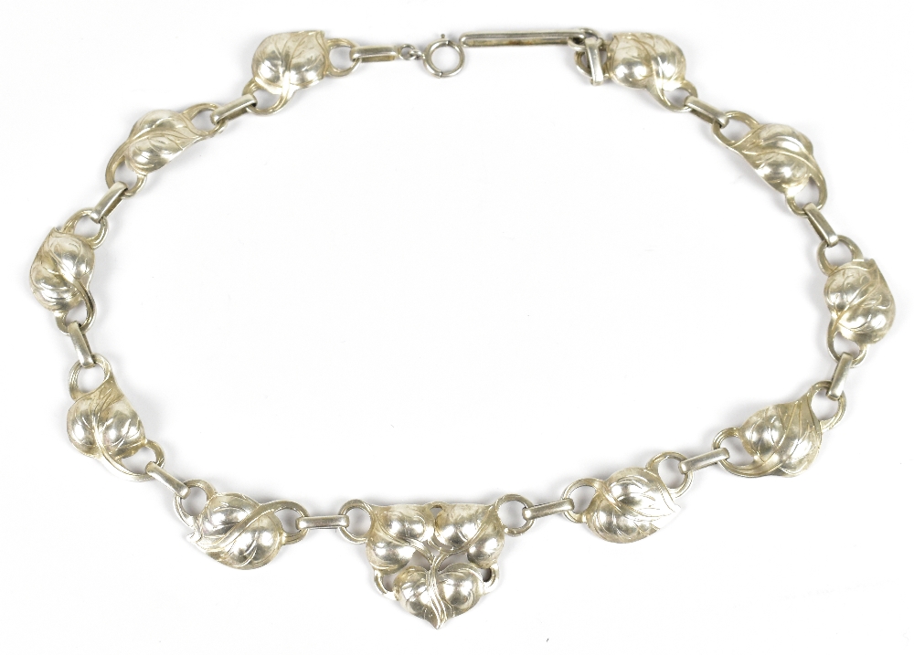A sterling silver necklace with cast floral decoration in the Art Nouveau style, length 40cm,