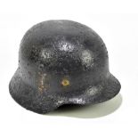 A German military helmet with traces of decal.