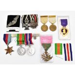 Three WWII medals, with a Croix de Guerre, a Purple Heart, two British Red Cross Society medals,